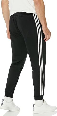 adidas Men's Essentials Fleece Tapered Cuffed 3-Stripes Pants, Black/White, Small in Saudi Arabia