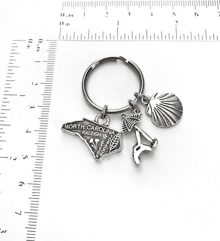 North Carolina beach theme keychain. Includes State of North Carolina, Beach Chair with Umbrella, and Seashell in Saudi Arabia