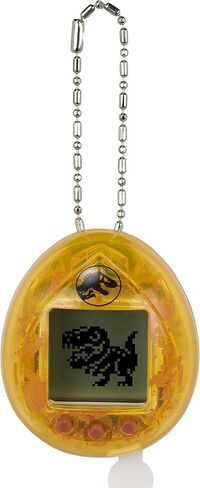 الذكرى السنوية الثلاثين لـ Tamagotchi Nano x Jurassic Park - إصدار Dinosaur Amber. in Kuwait