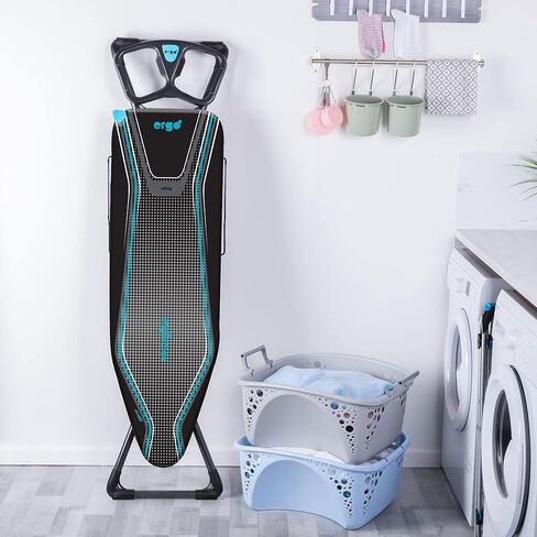 طاولة الكي مينكي إيرجو بلس بروزون | صنع في المملكة المتحدة | غطاء عاكس للحرارة، تصميم حلقة ساق ثابتة ورف من الكتان - لوح كي قائم بذاته مع سطح كي كبير مقاس 48 بوصة × 15 بوصة (معدني وأزرق) in Kuwait