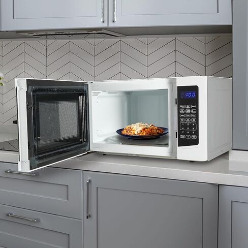 West Bend WB01100MWVW Microwave Oven Compact with 10 Power Levels and 6 Pre Cooking Settings, Speed Defrost, Electronic Control Panel and Glass Turntable, 1.1-Cu.Ft, White in Saudi Arabia