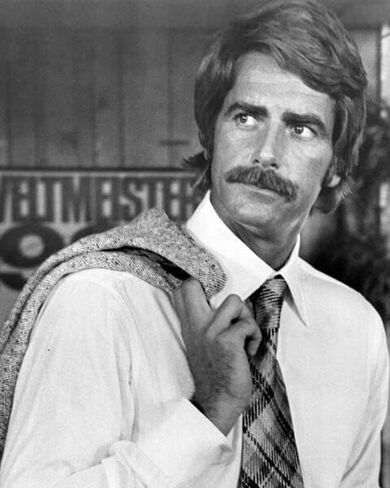 Sam Elliott in shirt & tie holding jacket 1976 Lifeguard 8x10 inch photo in Saudi Arabia