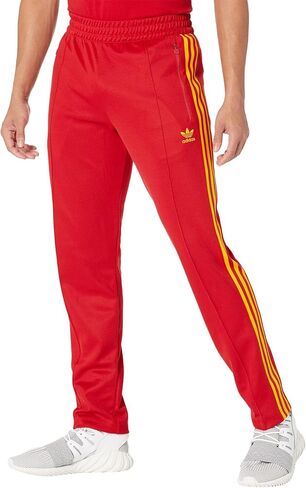 بنطال رياضي Beckenbauer من adidas Originals، Team Power Red/Team Collegiate Gold SM in Saudi Arabia