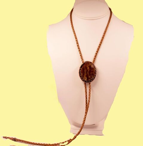 A Deep Red and Gold Jasper Cabochon is in a Copper Tone Bolo Slide with Copprt Tone Leather Cord and Swirl Tips in Saudi Arabia