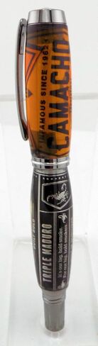 Handmade Artisan Jr Gentleman II style rollerball pen. Camacho cigar label collage in clear acrylic. Black titanium trim. Screw off postable cap. Black ink. in Saudi Arabia