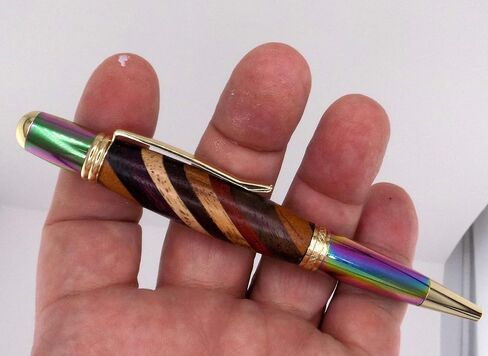 Handmade Sierra Mesa ballpoint pen. Layered hard woods. Metallic prismatic and gold trim. Black ink. in Saudi Arabia