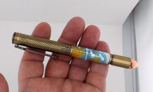 Handmade 45 Caliber themed ballpoint pen. Brass trim. Orange, blue and white acrylic. Clicks to open. in Saudi Arabia
