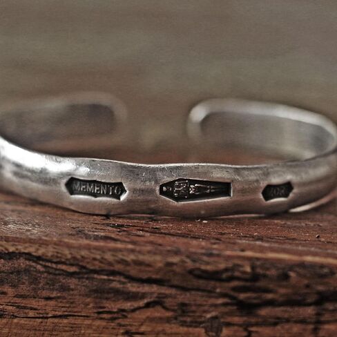 Steel punch imprinted memento mori silver cuff bracelet in Saudi Arabia