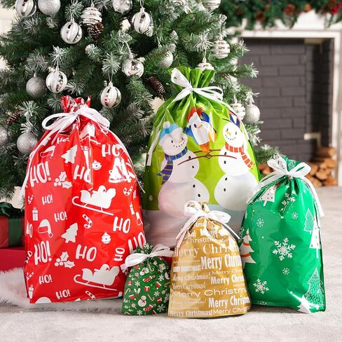 JOYIN 24 Pcs Christmas Drawstrings Foil Gift Bags, Xmas Wrapping Gift Assorted Styles Bag with present Tag for Christmas Holiday Party Favor, Reusable Wrap Goodie Bag Decorations in Saudi Arabia