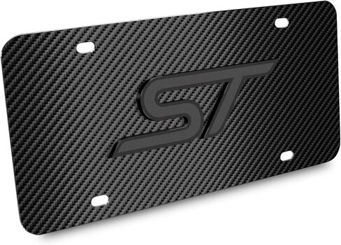 صورة iPick لشعار Ford Focus ST ثلاثي الأبعاد باللون الرمادي الداكن على لوحة ترخيص من الفولاذ المقاوم للصدأ بنمط ألياف الكربون الأسود - مرخصة رسميًا in Kuwait
