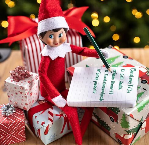 Elf on The Shelf فتاة الكشافة ذات العيون الزرقاء مع كتاب تقاليد عيد الميلاد مقترنًا بفستان صغير بهرج من Claus Couture® الجديد in Saudi Arabia