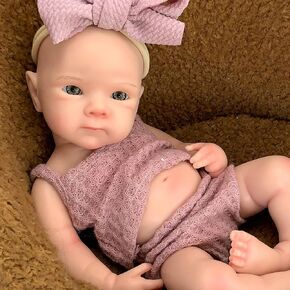 دمية ريبورن بيبي - بيتي 13 بوصة، صحيحة تشريحيًا، دمية سيليكون ناعمة واقعية مع فستان بفيونكة وردي داكن in Kuwait