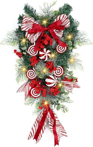 Yunlly 28" Pre Lit Christmas Teardrop Swag Battery Operated Christmas Swag with Lights, Red and White Bowknot, Swirl Candy Cane Ball, Xmas Wreath Ornament for Indoor Outdoor Front Door Decoration in Saudi Arabia