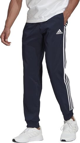 adidas Men's Athletics Essentials 3 Stripes Tapered Tricot Pant in Saudi Arabia