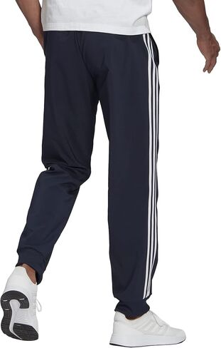 adidas Men's Athletics Essentials 3 Stripes Tapered Tricot Pant in Saudi Arabia