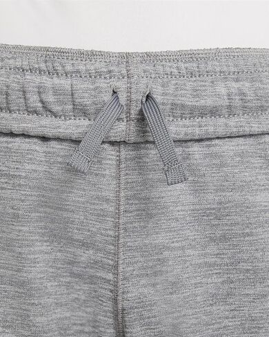 بنطال تدريب مدبب برسومات جرافيك للأطفال الكبار (للأولاد) من Nike Therma-FIT (صغير، رمادي دخاني/هيذر) in Saudi Arabia