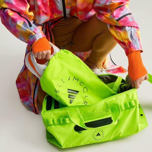 حقيبة ADIDAS BY STELLA MCCARTNEY 24/7، 10.5 بوصة × 19.75 بوصة × 11 بوصة، سلايم شبه شمسي/أسود/أزرق متوهج in Saudi Arabia