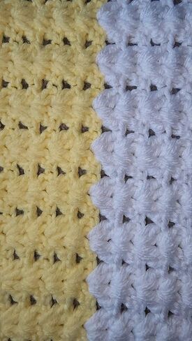 Yellow and white baby blanket in Saudi Arabia