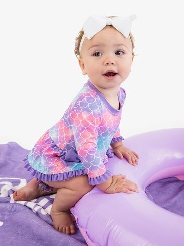 بدلة سباحة RuffleButts للفتيات الصغيرات بعامل حماية من الأشعة فوق البنفسجية 50+ بأكمام طويلة قطعة واحدة مع فيونكة بيبلوم للحماية من الطفح الجلدي in Saudi Arabia