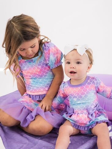 بدلة سباحة RuffleButts للفتيات الصغيرات بعامل حماية من الأشعة فوق البنفسجية 50+ بأكمام طويلة قطعة واحدة مع فيونكة بيبلوم للحماية من الطفح الجلدي in Saudi Arabia