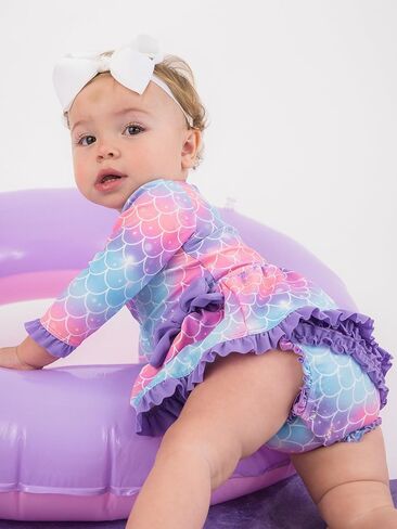 بدلة سباحة RuffleButts للفتيات الصغيرات بعامل حماية من الأشعة فوق البنفسجية 50+ بأكمام طويلة قطعة واحدة مع فيونكة بيبلوم للحماية من الطفح الجلدي in Saudi Arabia