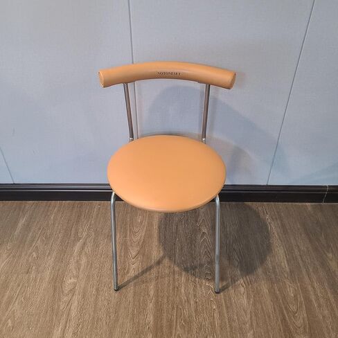 NOTONESET Dining chairs – Stylish and minimalist design, with a curved faux leather backrest and metal legs, exuding a modern feel. in Saudi Arabia
