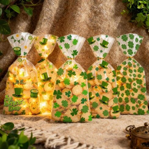 أكياس حلوى السيلوفان لعيد القديس باتريك من BIWONUI - 100 قطعة من حقائب هدايا الحفلات الخضراء لعيد القديس باتريك مع حقيبة بلاستيكية برباط ملتوي لحلوى الفشار والكوكيز والوجبات الخفيفة ومستلزمات حفلات العطلات in Kuwait