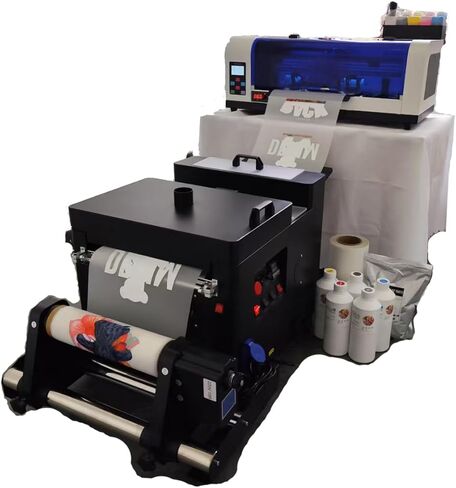 طابعة XP600 DTF مزودة بآلة مجفف اهتزاز، مستقرة وملونة، وتتضمن حبرًا وفيلمًا ومسحوقًا بحجم 5 × 500 مل in Kuwait