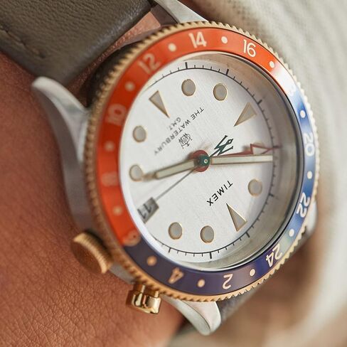 Timex Men's Waterbury Traditional GMT 39mm Watch – Stainless Steel Case White Dial Red/Blue Top Ring Gold-Tone Accents with Black Genuine Leather Strap in Saudi Arabia