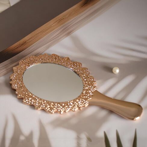 مرآة يد كلاسيكية من OIGUMR، مرآة مكياج بيضاوية محمولة مقاس 9.5 × 5 بوصة للنساء، مرآة زينة للسفر بمقبض مزخرف (1، ذهبي وردي، 9.5 × 5 بوصة) in Kuwait