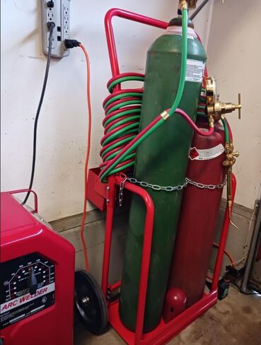 Red Steel Welding Cart Hauls Welding Tanks Torch Equipment Over Rough Terrain in Kuwait