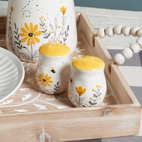 Primitives by Kathy Salt & Pepper Set - features bees buzzing over flowers with yellow accents. Shakers include unique openings to tell them apart, with plastic stoppers for easy refilling & cleaning in Saudi Arabia