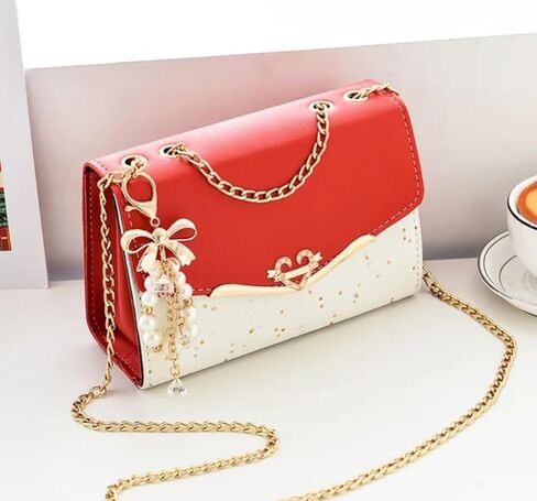 Women's Crossbody Satchel Handbag with Gold Chain Strap, Bow and Pearl Charm decoration. in Saudi Arabia