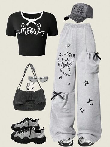 Girl's black short sleeved top with bow letters and cat print, paired with light gray straight leg pants in Kuwait