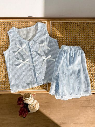 Girl's sleeveless top and shorts set, featuring a striped printed tie, bow, and ruffled hem design in Kuwait