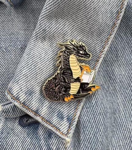Dragon Reading Book Enamel Pin, Black and Gold Fantasy Lapel Pin, 4cm x 3.77cm, 1.5 inches in Saudi Arabia