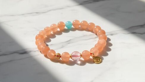 Peach Pink Beaded Bracelet with Turquoise Accent & Gold Coin Charm in Saudi Arabia