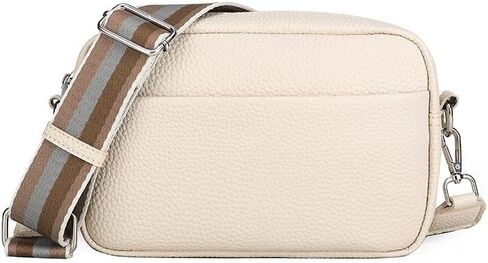 Women's leather crossbody bag, with a camera style, featuring a wide striped shoulder strap and a zipper closure. in Kuwait