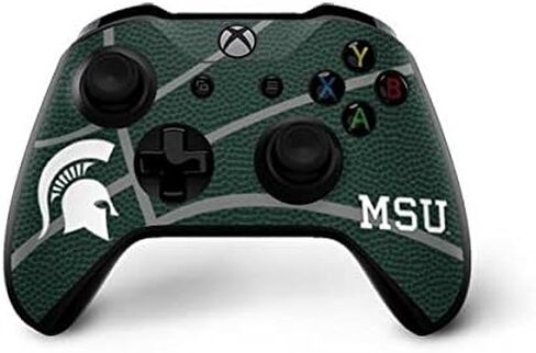 ملصق Skinit المخصص للألعاب متوافق مع وحدة تحكم Xbox One X - تصميم كرة السلة الأخضر لجامعة ولاية ميشيغان المرخص رسميًا in Kuwait