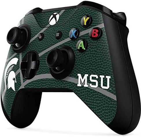 ملصق Skinit المخصص للألعاب متوافق مع وحدة تحكم Xbox One X - تصميم كرة السلة الأخضر لجامعة ولاية ميشيغان المرخص رسميًا in Kuwait
