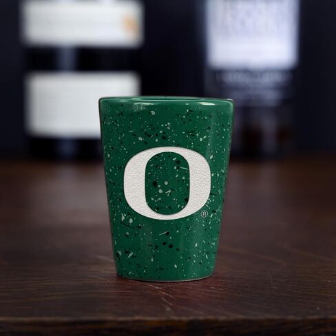 Rico Industries NCAA Oregon Ducks Standard 2oz Ceramic Shot Glass for Fans, Laser Engraved In Team Color Single Shot Glass in Kuwait