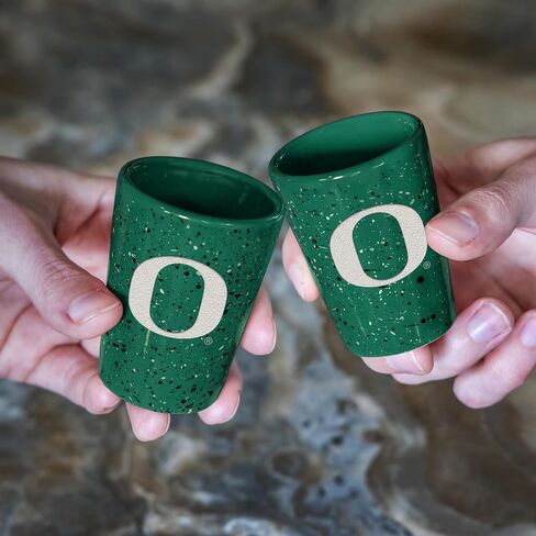Rico Industries NCAA Oregon Ducks Standard 2oz Ceramic Shot Glass for Fans, Laser Engraved In Team Color Single Shot Glass in Kuwait