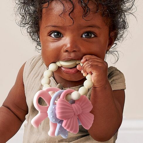 Itzy Ritzy Silicone Teether Trio for Babies - Soft, Flexible BPA-Free Teething Toys with Textured Surfaces & Easy-Grip Ring for Sensory Play and Fine Motor Skill Development (Bows) in Kuwait