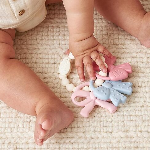Itzy Ritzy Silicone Teether Trio for Babies - Soft, Flexible BPA-Free Teething Toys with Textured Surfaces & Easy-Grip Ring for Sensory Play and Fine Motor Skill Development (Bows) in Kuwait