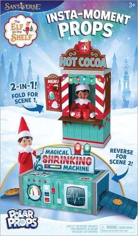 The Elf on the Shelf Insta-Props 2-in-1 Scene Kit with Reversible Pop Out Backdrop - Hot Cocoa Stand and Magic Shrinking Machine Scenes with Accessories in Kuwait