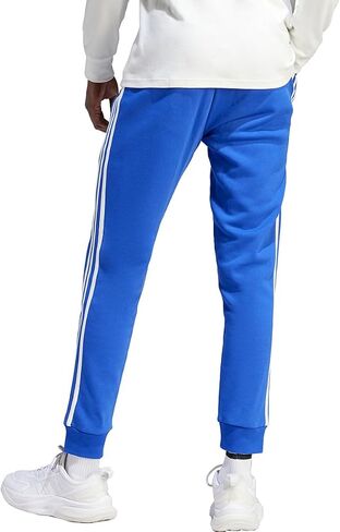 بنطال رجالي من adidas Essentials Fleece 3-Stripes بأساور مدببة، أزرق شبه شفاف in Saudi Arabia