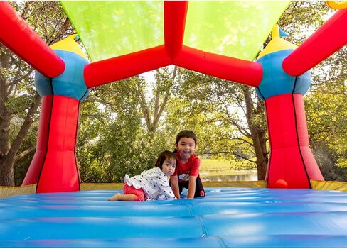 Bounceland Inflatable Party Castle Bounce House Bouncer, 16 ft L x 13 ft W x 10.3 ft H, Basketball Hoop, Removable Sun Roof, UL Strong Blower included, Fun Slide and Bounce Area, Castle Theme for Kids in Saudi Arabia