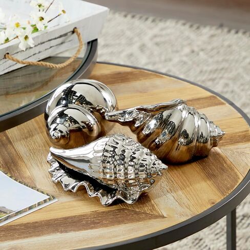 Deco 79 Ceramic Shell Decorative Sculpture Shell Home Decor Statues, Set of 3 Accent Figurines 7", 7", 5"W, Silver in Saudi Arabia