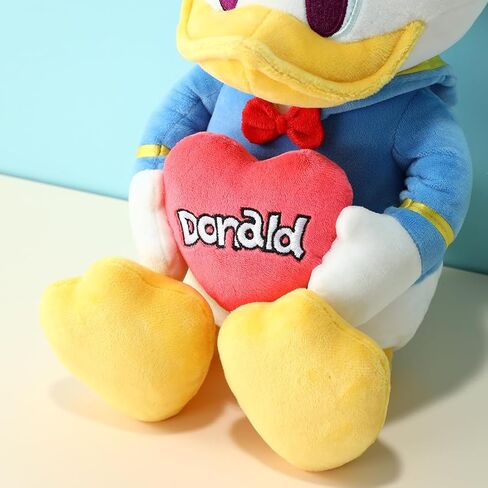 MINISO Disney Holding-Heart Plush Toy (Donald), Cuddly Stuffed Animal with Heart Emblem Soft and Huggable Collectible Toy for Disney Fans, Ideal for Bedtime Cuddles and Room Decor in Saudi Arabia