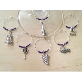 Vineyard themed Wine Charms. Includes Bottle, corkscrew, grapes, wine glasses with Cheers, picnic basket. Set of 6. PURPLE BEADS.